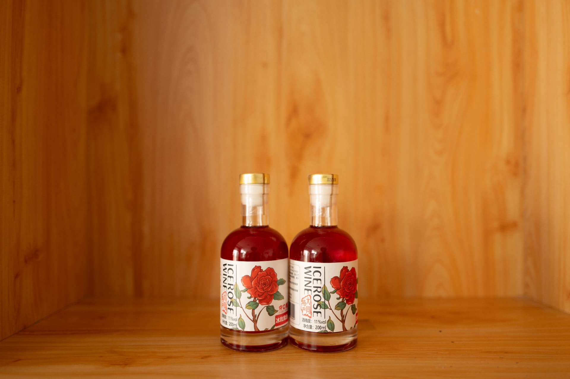 Ice rose wine bottles on a wooden shelf